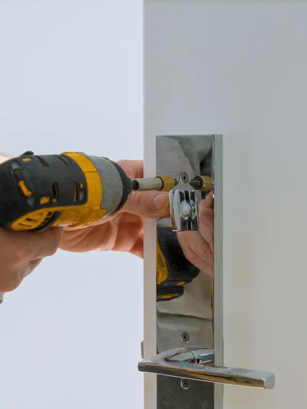 carpenter-fixing-lock-in-door-with-home-hand-close-2022-11-12-11-21-02-utc